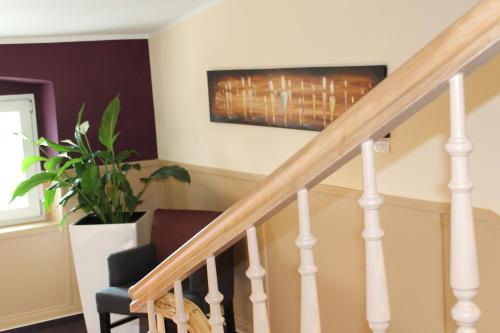 a staircase in a home with a painting on the wall at RheinHotel ARTE in Remagen