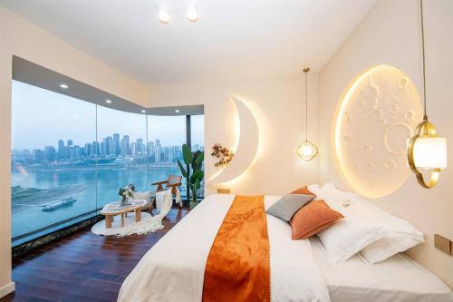 a bedroom with a bed and a view of the city at Baihong.Riverview Apartment in Chongqing