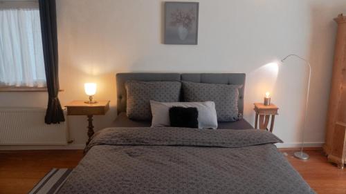 a bedroom with a bed with two candles on two tables at Schöne Ferienwohnung am nordwestlichen Rand des Taunus in Hünfelden