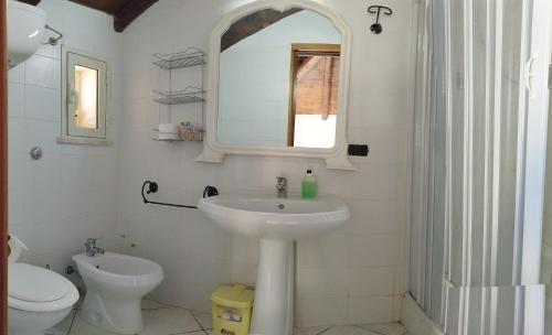 a bathroom with a sink and a toilet and a mirror at Hotel Bed&Breakfast Tiffany in Campobello di Licata