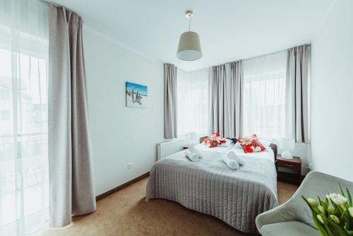 sypialnia z łóżkiem, kanapą i oknami w obiekcie Dom Wczasowy Twardowski w Łebie