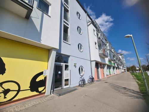 a building with a bike painted on the side of it at South Apartment - Modern & Stylish in Augsburg