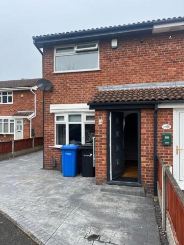 a brick house with a patio in front of it at 2 bed semi-detached house in Warrington