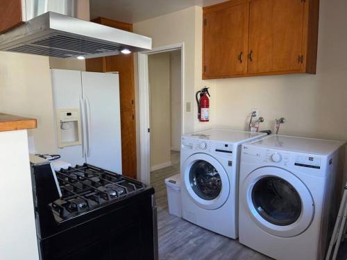 a kitchen with a stove and a washer and dryer at SUITE Queen Apart South-Bay Beaches in Gardena
