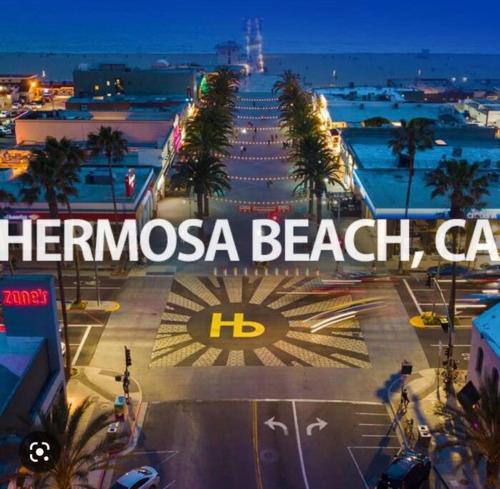 a sign that reads thermosa beach car in a parking lot at SUITE Queen Apart South-Bay Beaches in Gardena