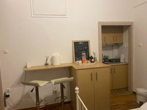 a small kitchen with a counter and a sink at Modern, ideally located studio apartment in Athens