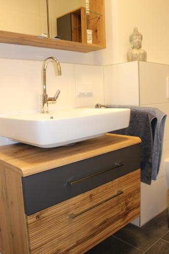 a bathroom with a sink on a wooden counter at Apartment Blicksüd in Unterburg am Klopeiner See