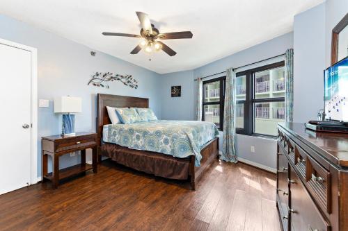 a bedroom with a bed and a ceiling fan at Harbor Place 206 in Gulf Shores