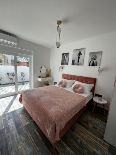 een slaapkamer met een groot bed en een raam bij LuxVilla AURORA in Vodice