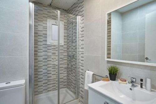 a bathroom with a shower and a sink and a mirror at Ideal 3 bedroom apartment in Sant Andreu in Barcelona