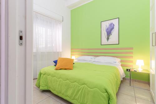 a bedroom with a bed with a green blanket at da ARMIDA VIP Flat in Naples