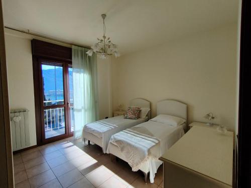 a bedroom with two beds and a window at Fabula Home Rental - GiannaRosa in Lovere