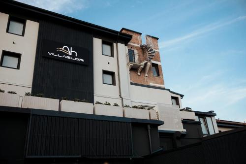 a building with a sign on the side of it at Ah Villaglori Boutique Apartments in Brescia