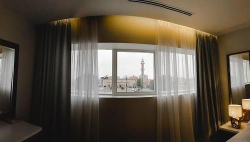 a room with a window with a view of a city at DIFFERENT HOTEL in Tabuk