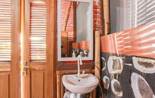 a bathroom with a sink and a mirror at RedDoorz Syariah at Banyu Asem Banyuwangi in Banyuwangi
