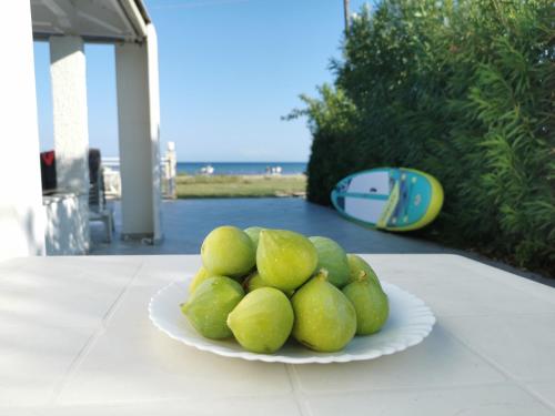 un plato de peras verdes sobre una mesa en Luxury Katakolo in front of the sea near Olympia, en Katakolon