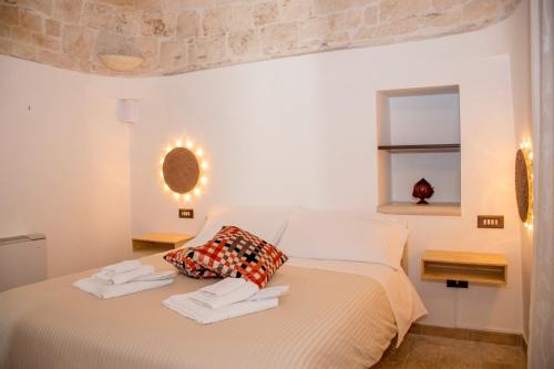 Postel nebo postele na pokoji v ubytování Pavì Trulli e Suites