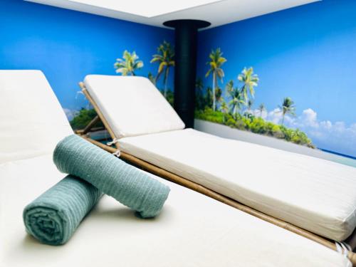 a room with two beds and a teddy bear at Wellness at Sea in Egmond aan Zee