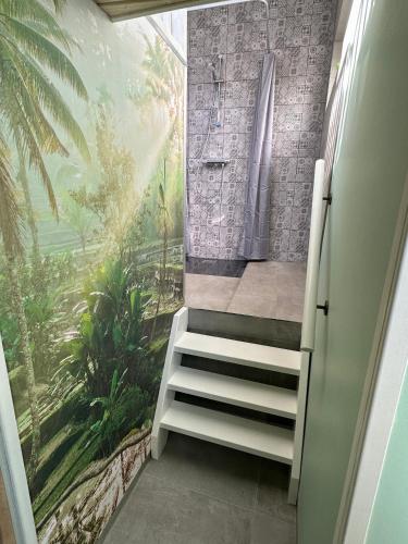 a bathroom with stairs leading to a shower and a window at Wellness at Sea in Egmond aan Zee