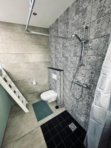 a bathroom with a shower and a toilet at Wellness at Sea in Egmond aan Zee
