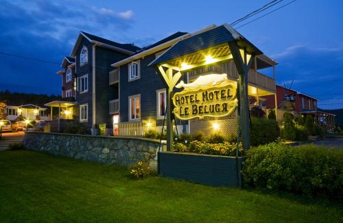 a sign in front of a hotel is building at Hôtel Motel Le Beluga in Tadoussac