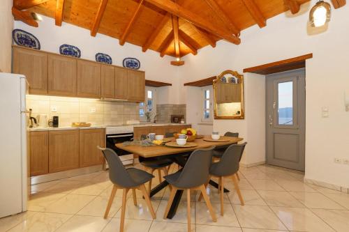een keuken met een houten tafel en stoelen bij Villa Maria - Hydra Dream Houses in Hydra