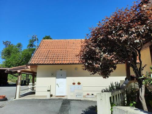 a small white house with a red roof at Casas do Caminho Velho in Ribeira de Pena