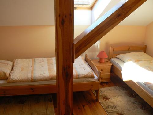 a bedroom with two bunk beds and a window at Staszkowa Zagroda nad Rospudą in Jabłońskie