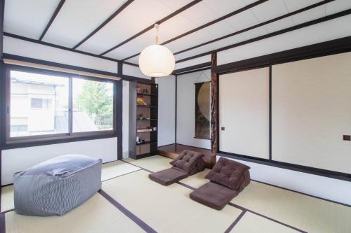 a living room with two chairs and a large window at FTH maroon 4min to station in Azagawa