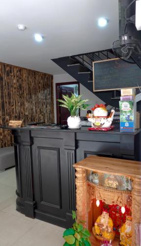 a kitchen with a black counter top in a room at Saigon Hub Hostel in Ho Chi Minh City