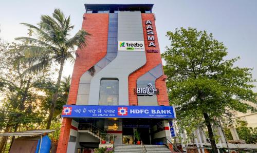 a building with a sign in front of it at Treebo Trend Aasma Downtown in Bhubaneshwar