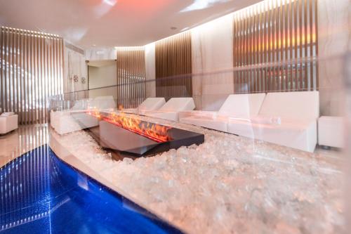 a lobby with a fireplace in the middle of a room at Park Hotel Imperial in Limone sul Garda