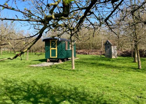 a small green train in a field with trees at 't Keetje in Groesbeek