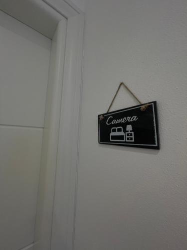 a sign hanging on a wall next to a door at La casa del capitano in Levanto