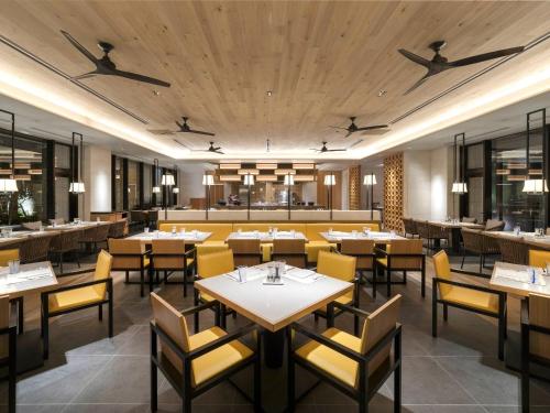 a dining room with tables and chairs in a restaurant at Hyatt Regency Seragaki Island Okinawa in Onna
