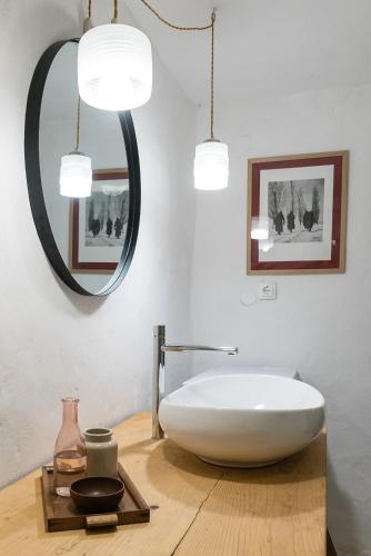 a bathroom with a white tub and a mirror at Hiša Borov Gaj in Mojstrana