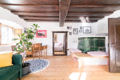 a living room with a green couch and a table at Hiša Borov Gaj in Mojstrana