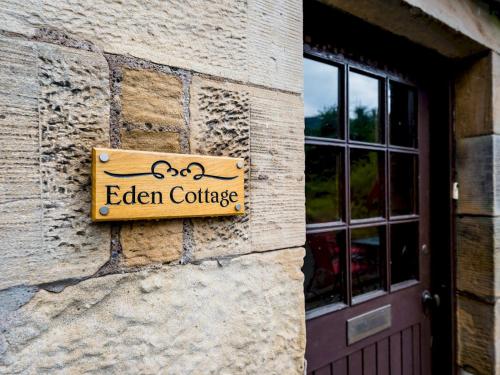 a sign on the side of a building at Pass the Keys 3 Bedroom Cottage in Cupar in Cupar