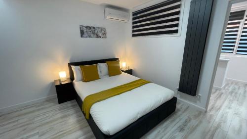 a bedroom with a bed with yellow pillows at LUXURY STUDIO in Onești