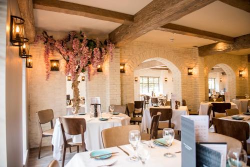 a dining room with white tables and chairs at The Briar Court Hotel in Huddersfield