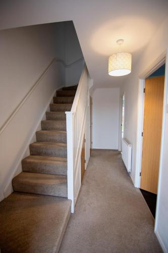 a staircase in a house with a stair case at Old Sarum House in Old Sarum
