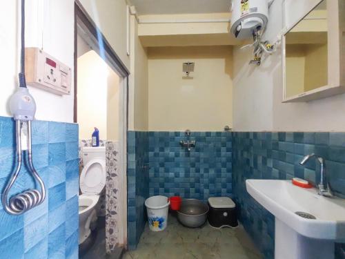 a bathroom with a sink and a toilet at Neora Backpackers Hostel in Darjeeling