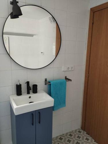 a bathroom with a sink and a mirror at Casa rural El olivo in Puigmoreno