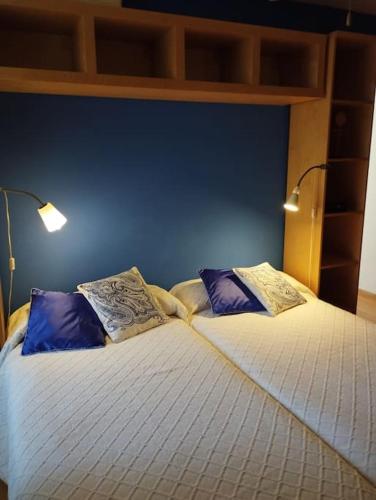 a bedroom with a bed with two pillows on it at Casa rural El olivo in Puigmoreno