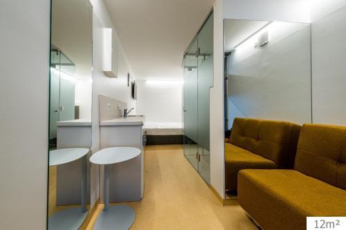 a living room with a couch and a table at Smart Nano Living - Wien Hauptbahnhof in Vienna