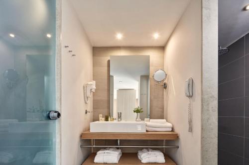 a bathroom with a sink and a mirror at Atlantica Mikri Poli Crete in Makry Gialos