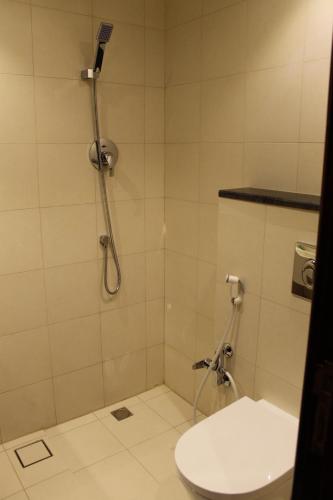 a bathroom with a shower with a toilet at High Village Hotel in Al Namas