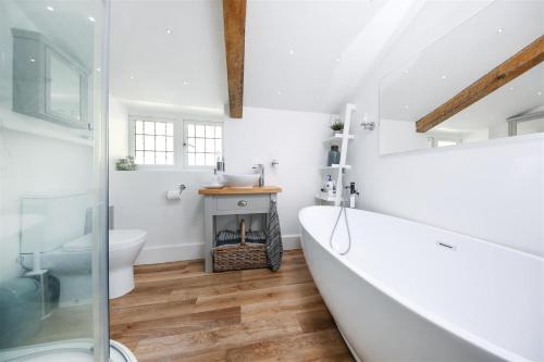 a bathroom with a fireplace and a bath tub at Cyclists Rest Matlock in Matlock