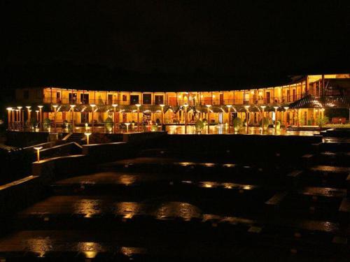 a building with lights in front of it at night at Aamby Valley City in Lonavala