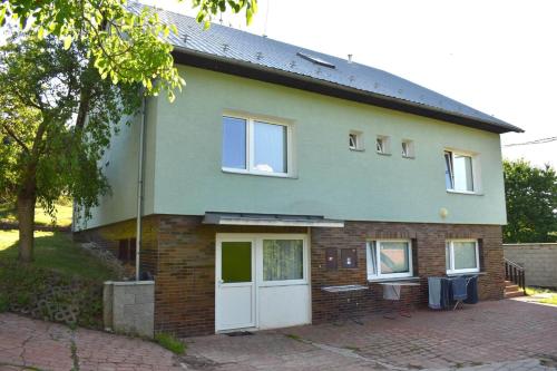 a brick house with a white door and windows at Penzion Era in Zlín